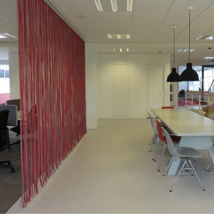 Room divider made of red ropes office interior